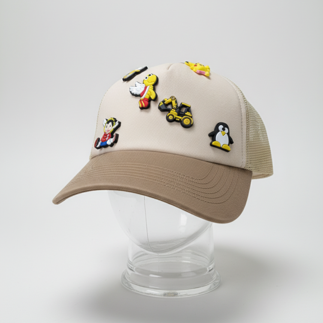 Cream cap with a tan peak, removable rubber charms and a tan mesh back