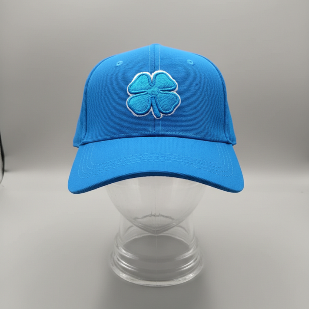 Bright blue cap with a raised clover embroidery in blue and white