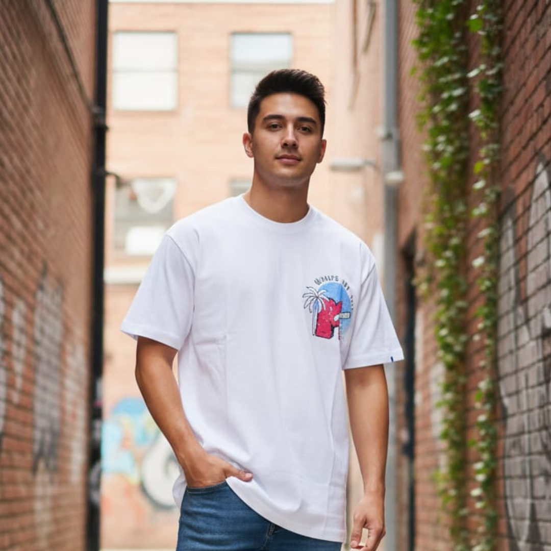 White t-shirt with a small red palm and arch graphic on the chest
