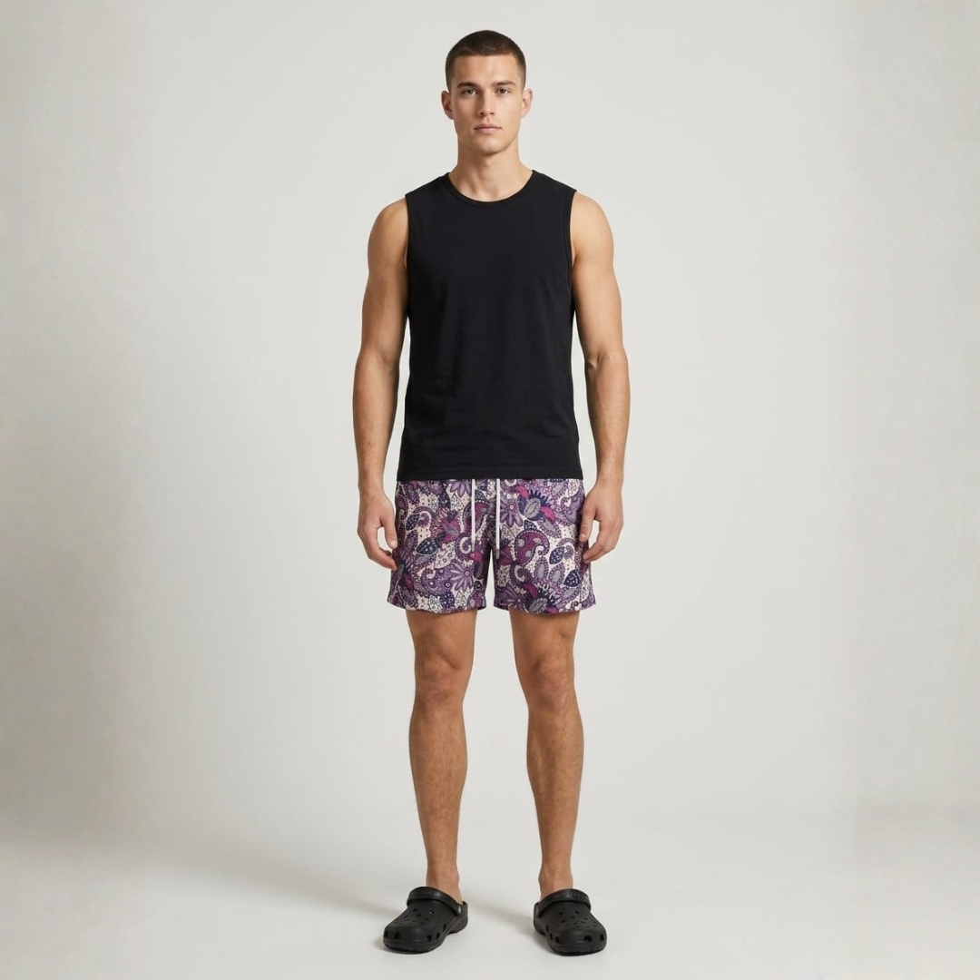 Cream sea shorts with a purple paisley pattern and a white tie, front view
