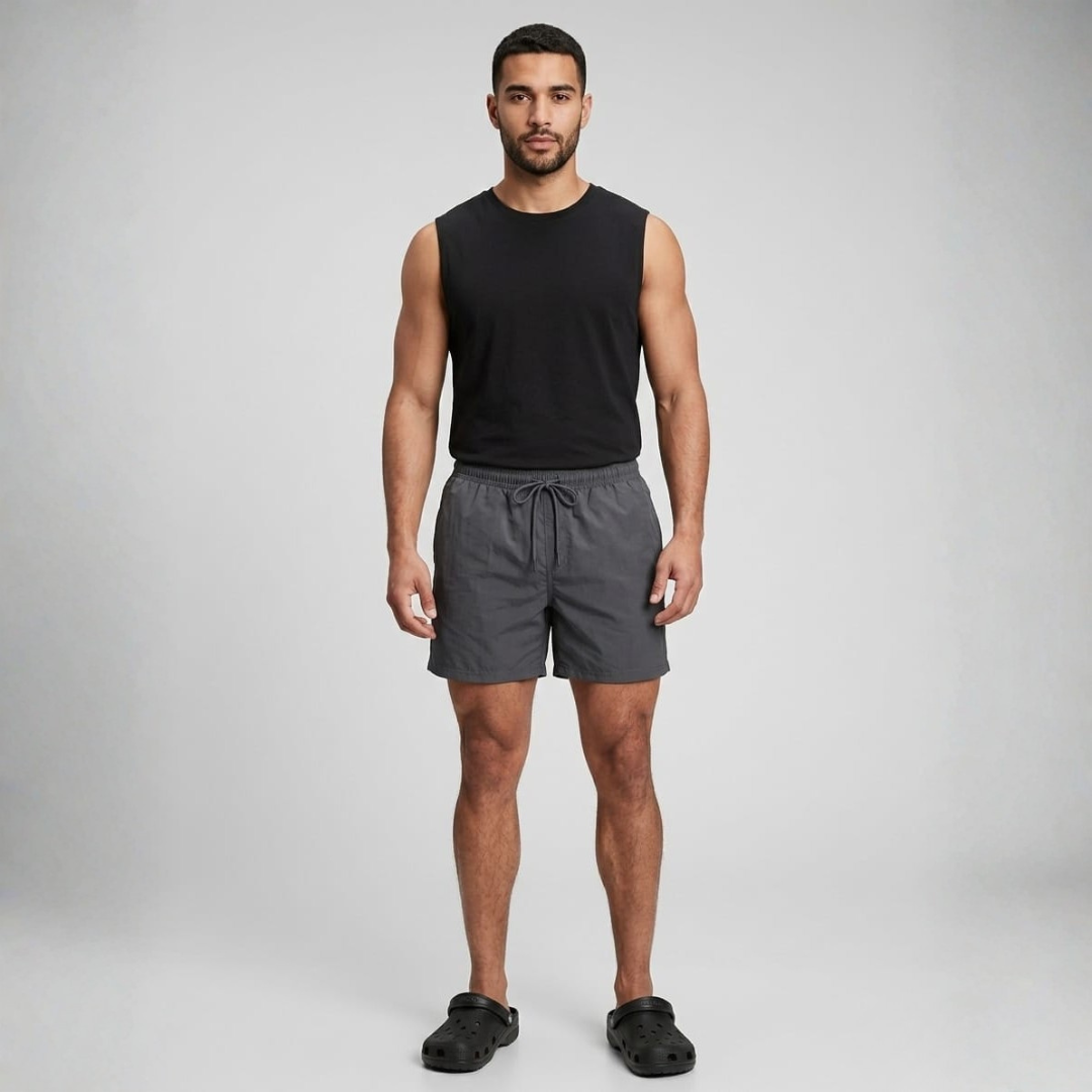 Plain charcoal grey swim shorts with an elastic waist and a front drawcord