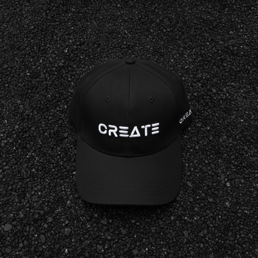 Black cap with white embroidered lettering across the front and a curved brim