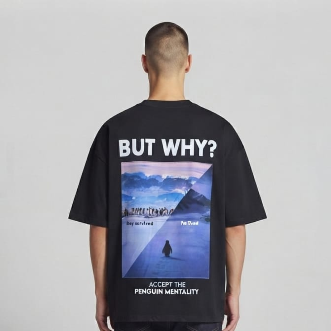 Black t-shirt with a framed snowy scene with penguins, large white lettering above and lines below