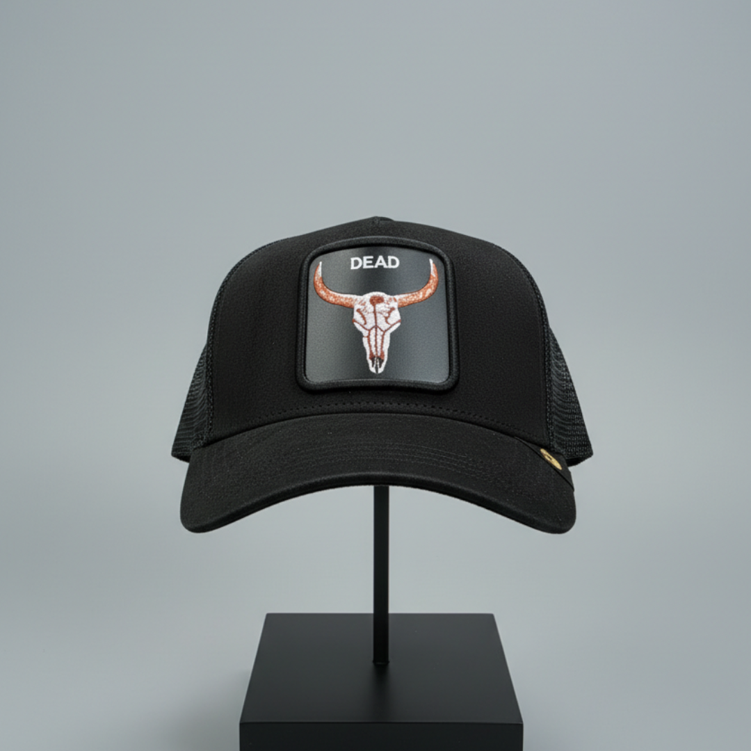 Black trucker cap with a square patch of a horned skull and a mesh back