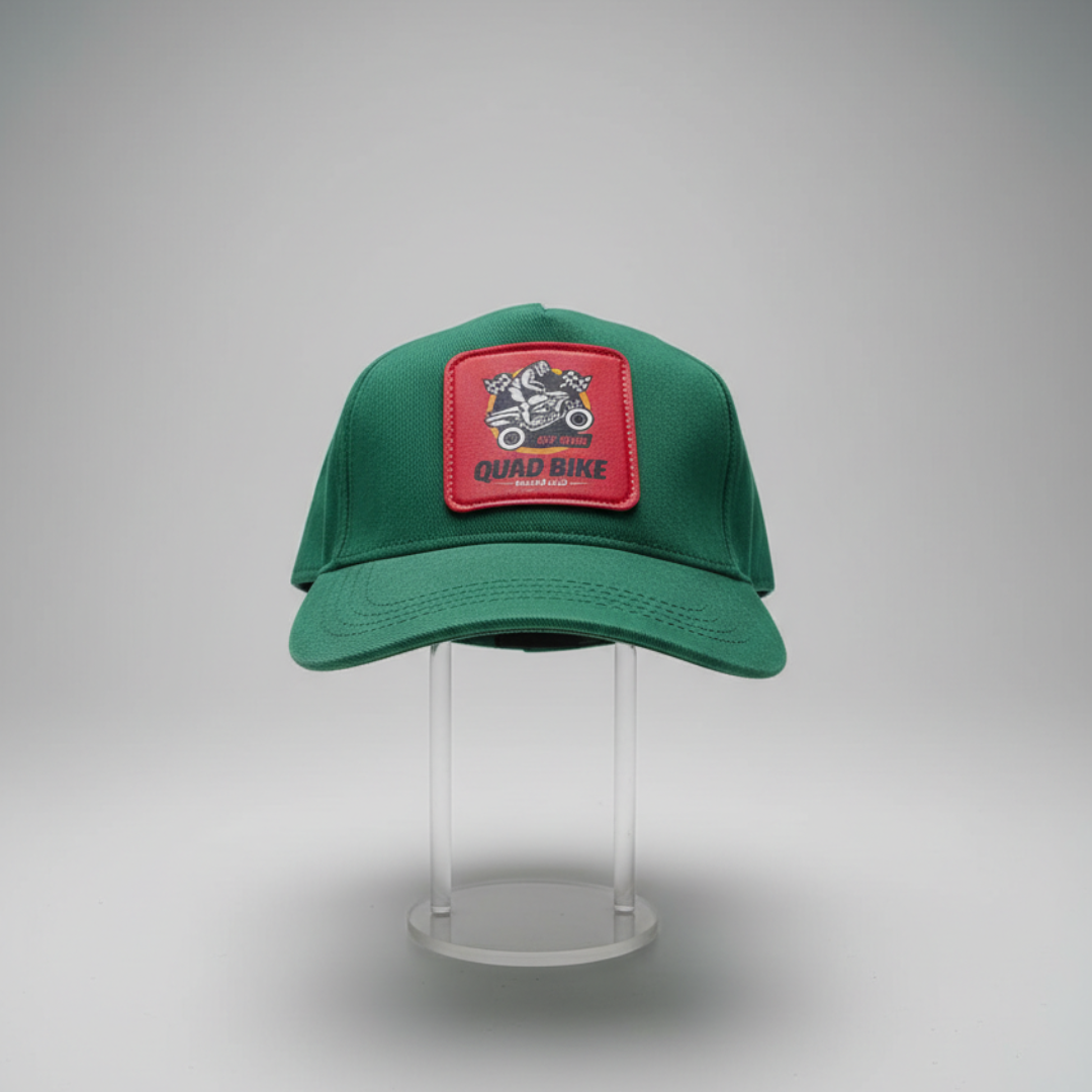 Green cap with a red patch of a quad bike and two flags at the front