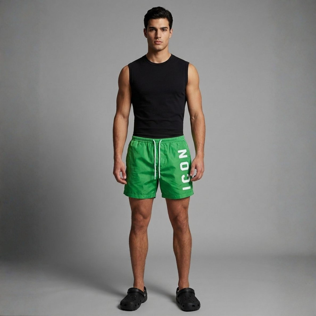 Green jumbo sea shorts with white lettering on the leg and a white drawstring