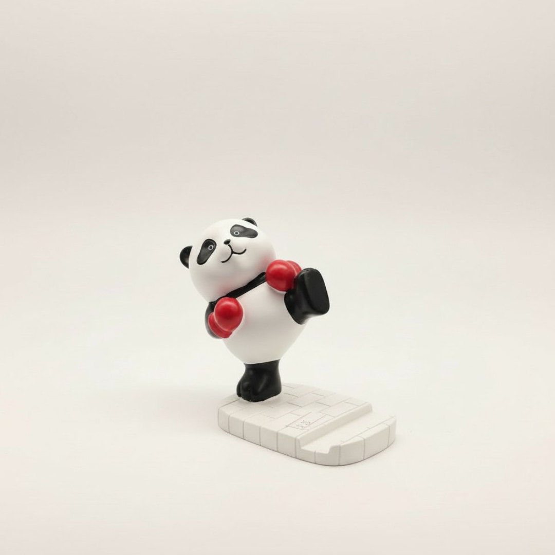 Black and white panda figure phone stand in red boxing gloves standing on a white tiled base