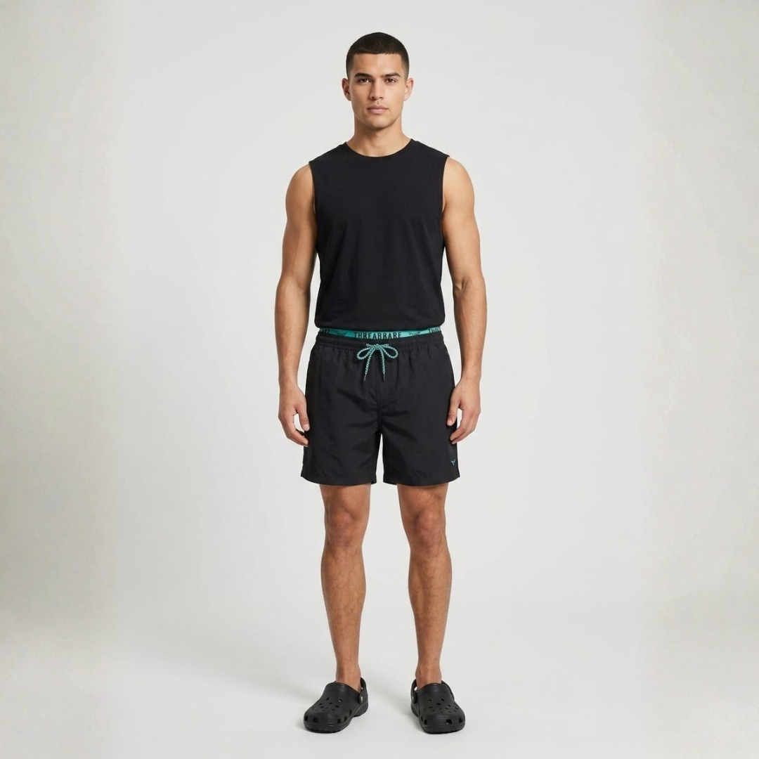 Plain black swim shorts with a green waistband and a green drawcord