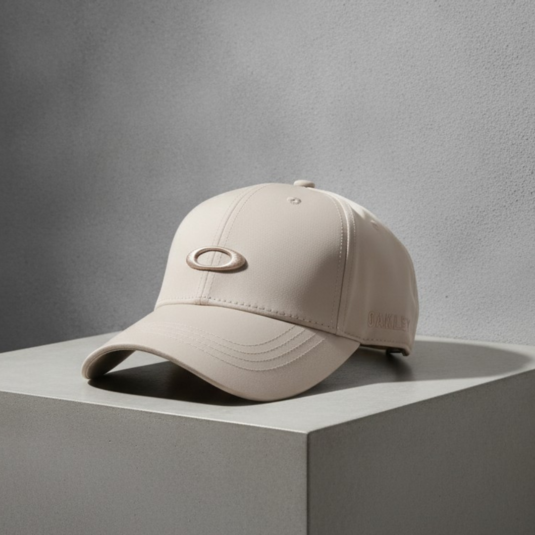 Sand cap with a tonal oval emblem at the front and a raised text mark on the side