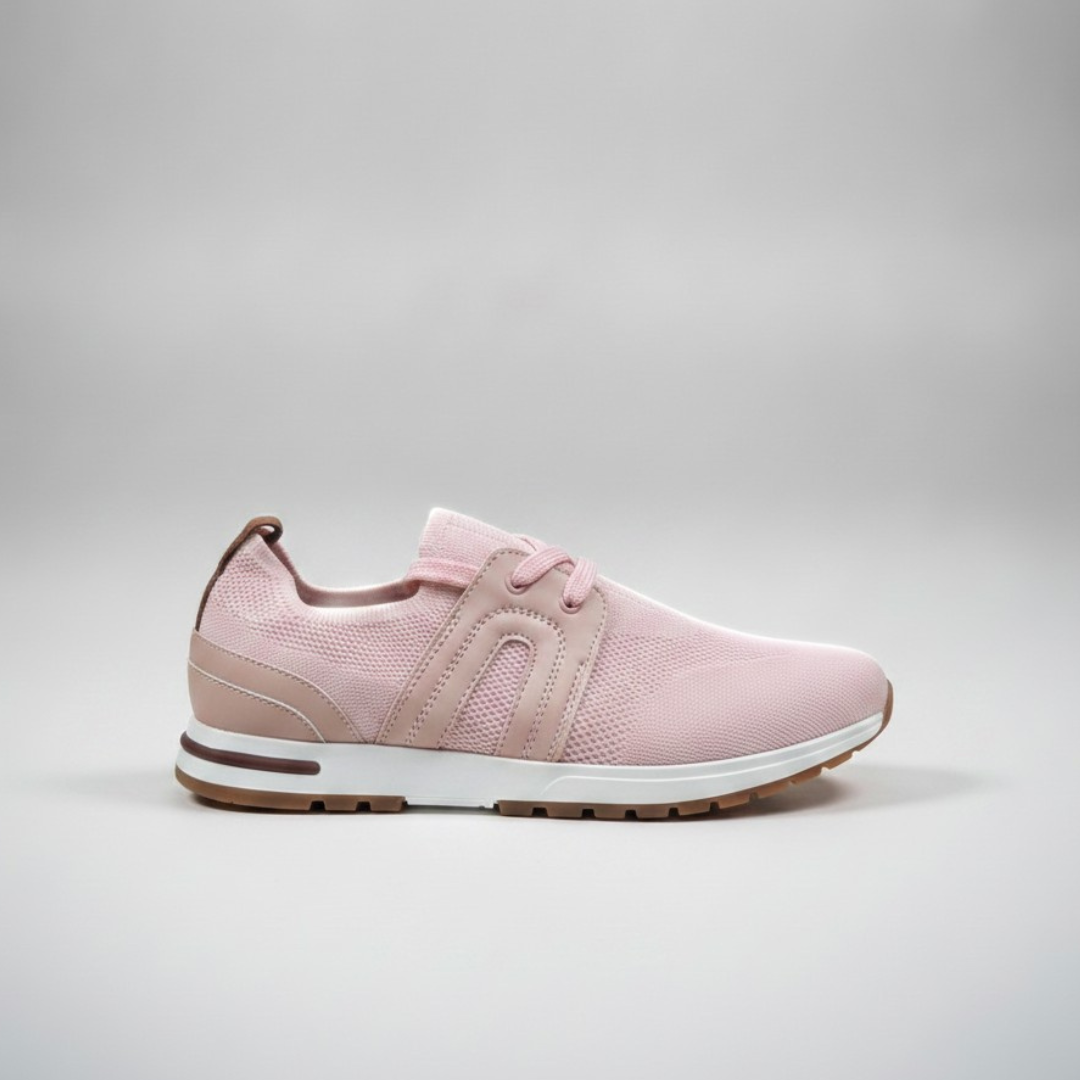 Pale pink knit shoe with a tonal side curve and a white sole on a tan base