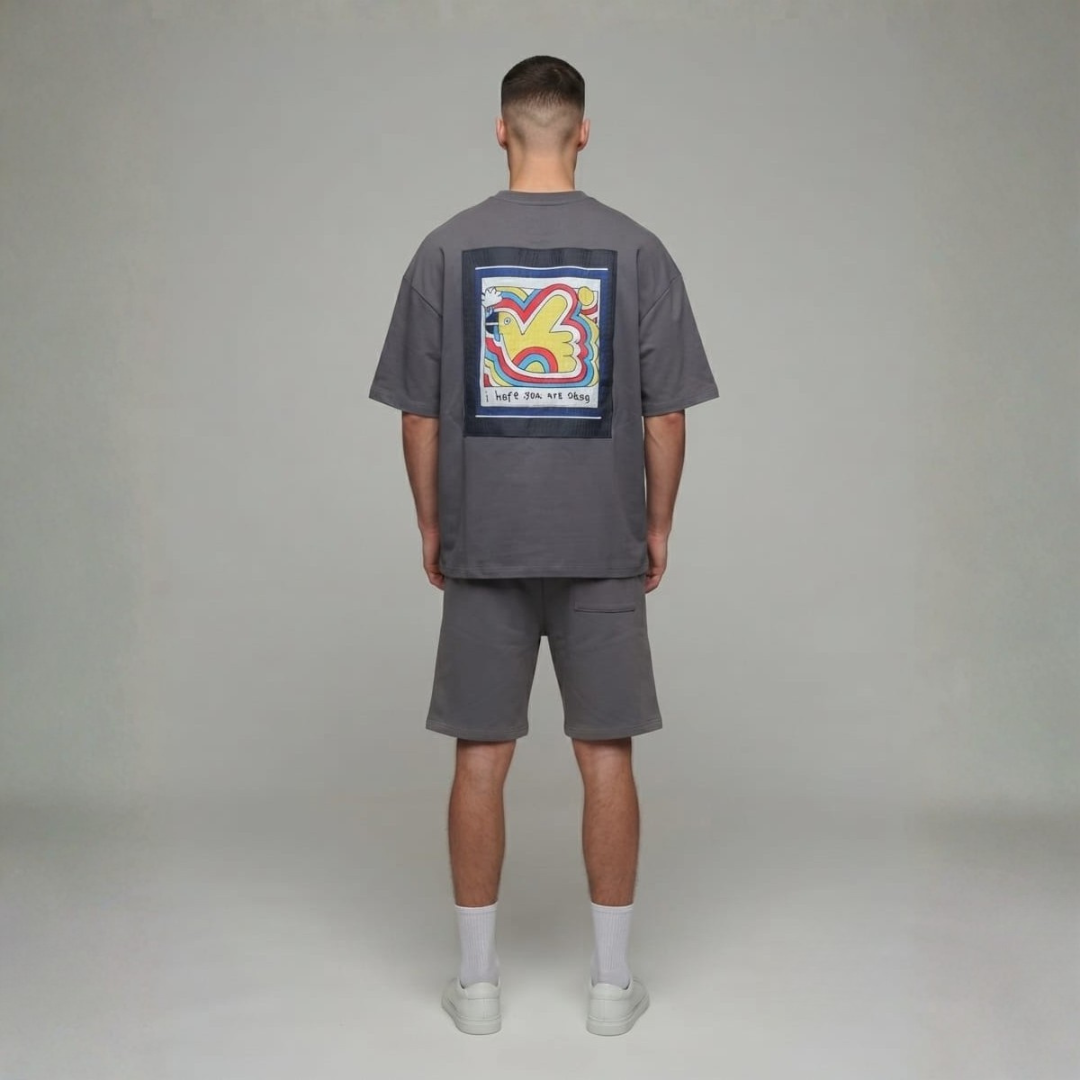 Grey tee and shorts set from the back with a large colourful square print of a bird shape