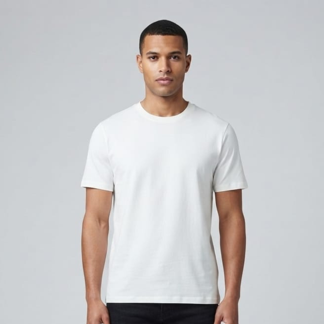 Man in an ivory white tee with short sleeves and a round neck, facing forward on a pale grey backdrop