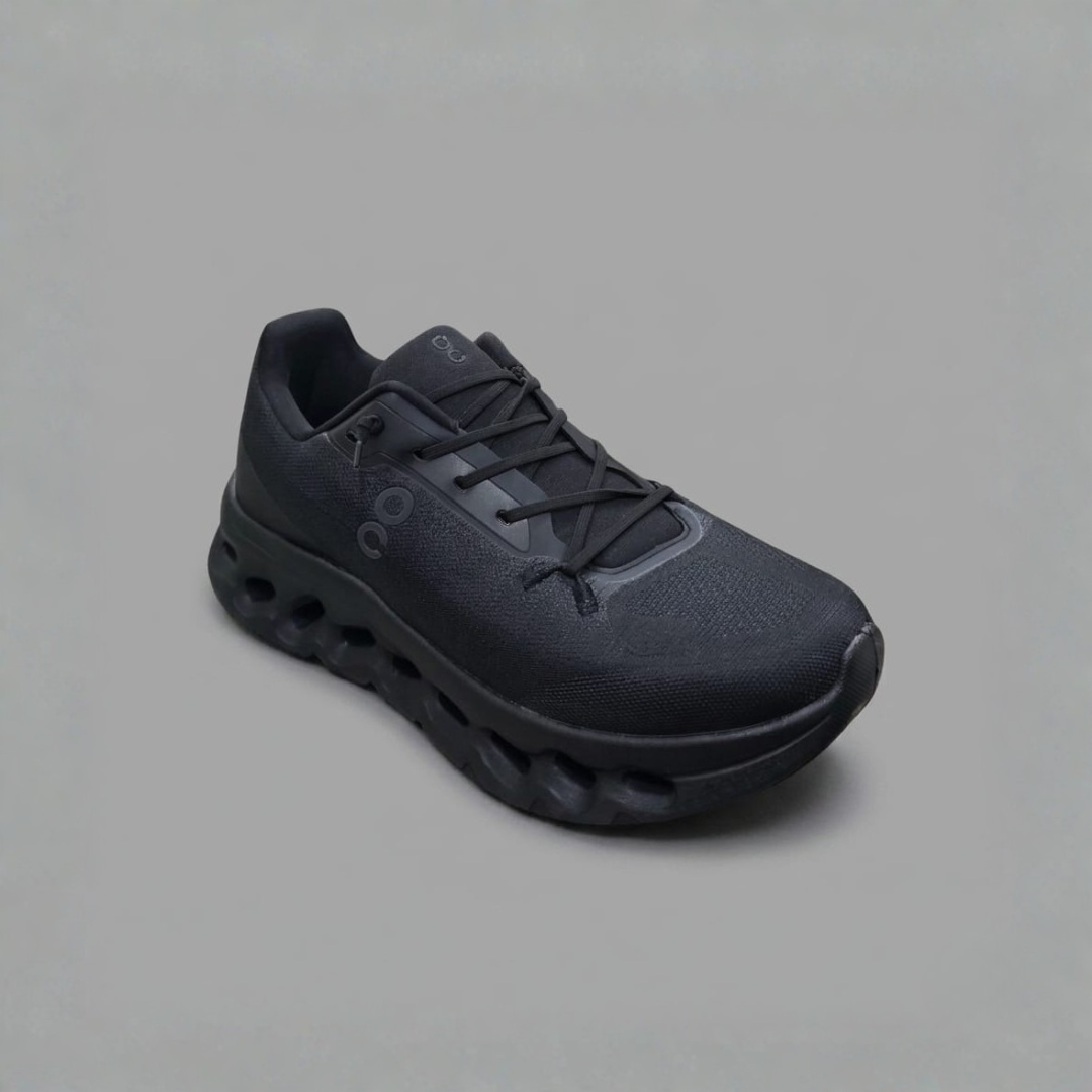 Men Shoes in black with a small tonal side mark, black laces and a thick wavy black sole